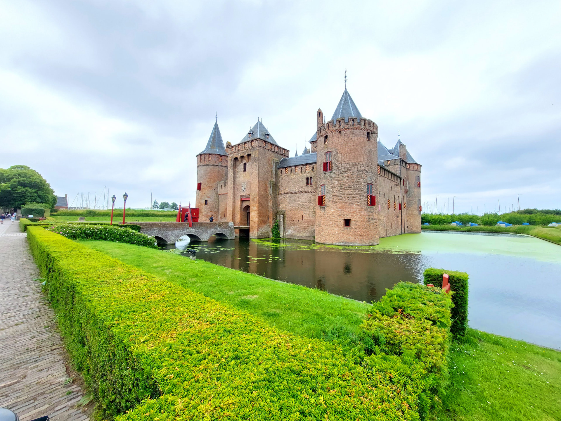 Het Muiderslot aan het water bij Muiden, met slotgracht en jachthaven op de achtergrond